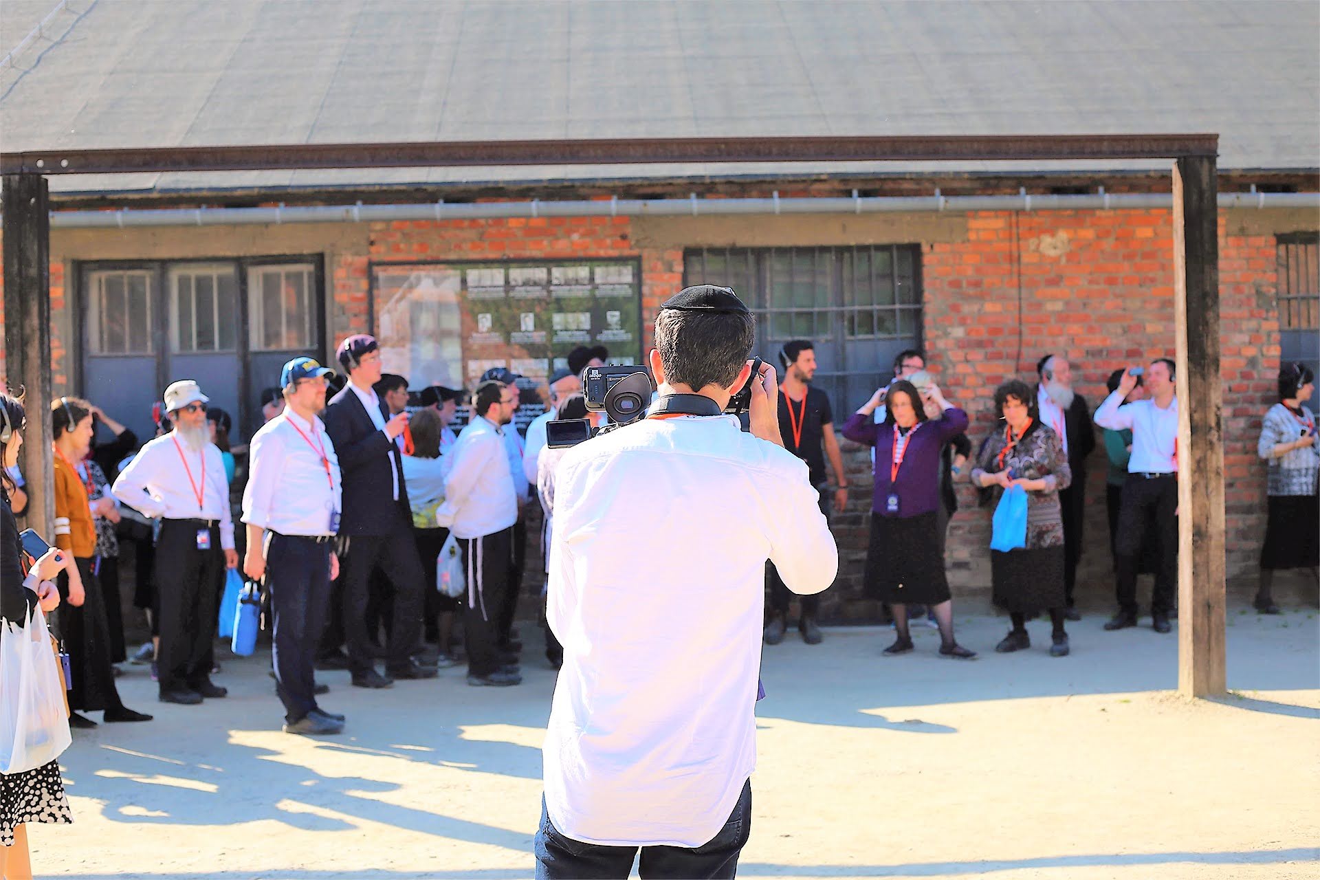Group paying respects outside a brick building at the Memorial