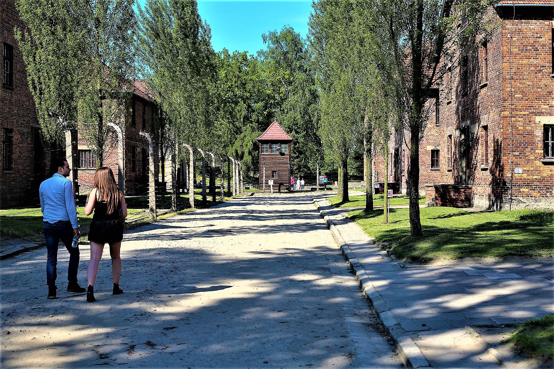 Tree-lined avenue between barracks with guard tower