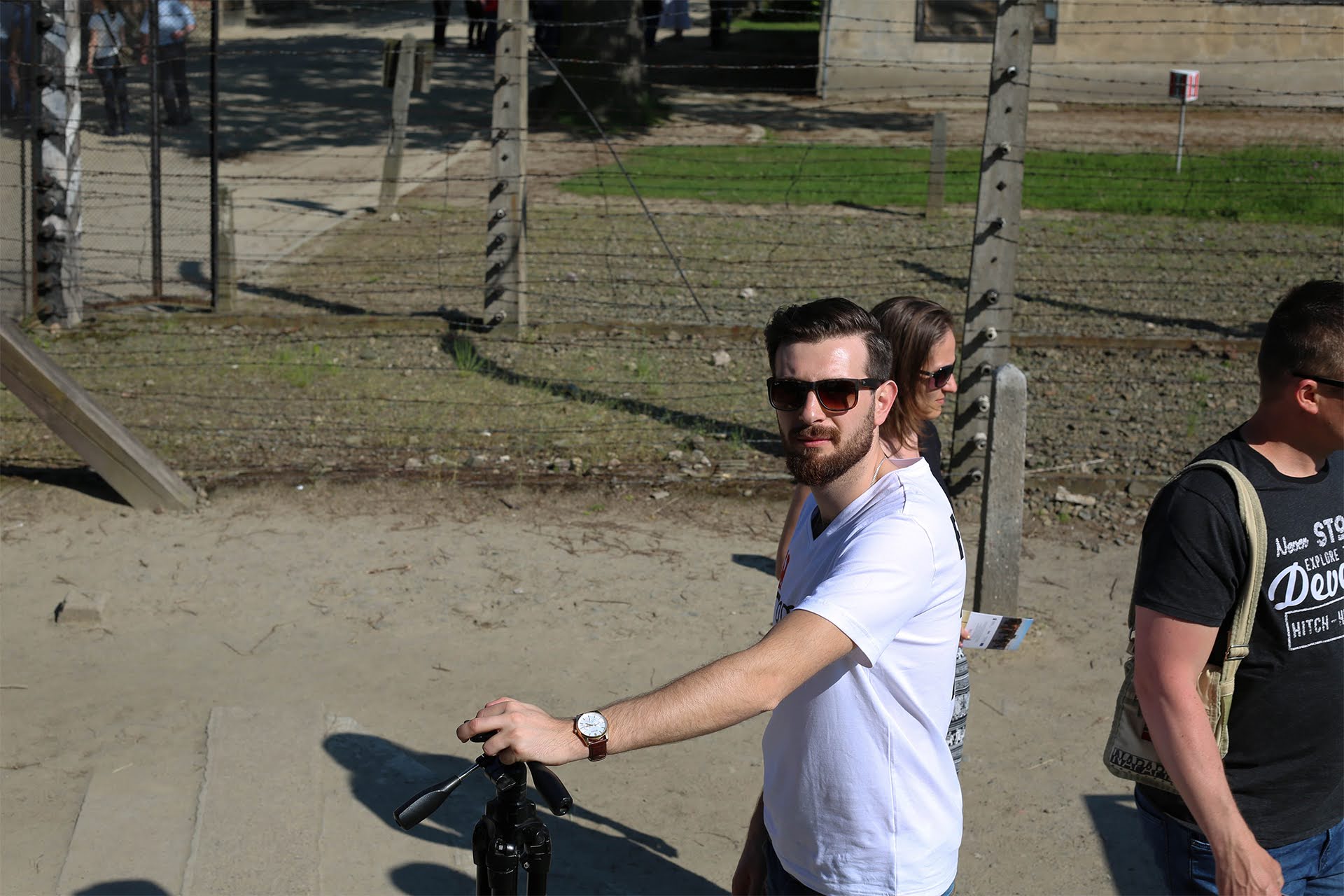 Tour guide leading a group at the Auschwitz Memorial