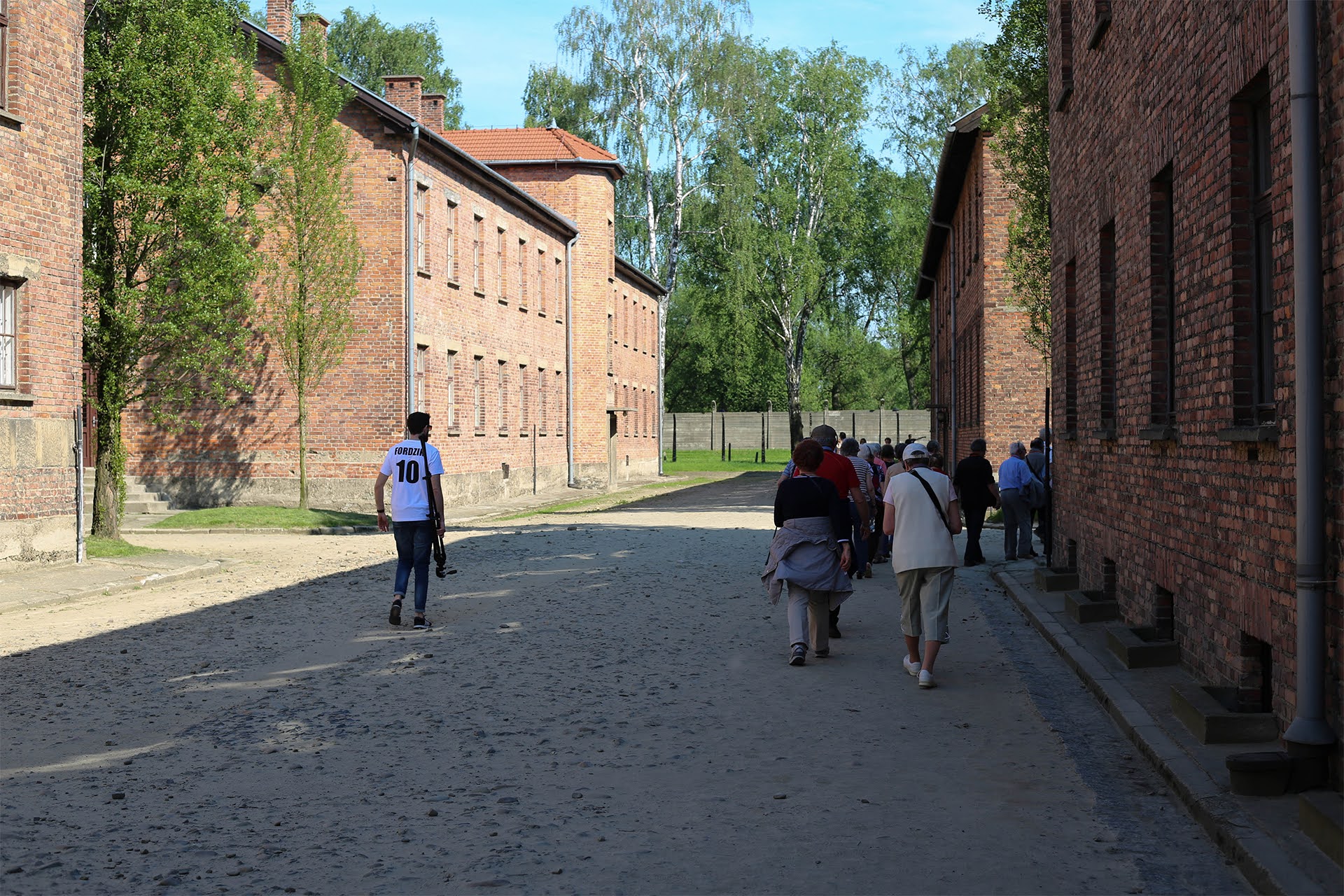 Group walking the path between prisoner blocks