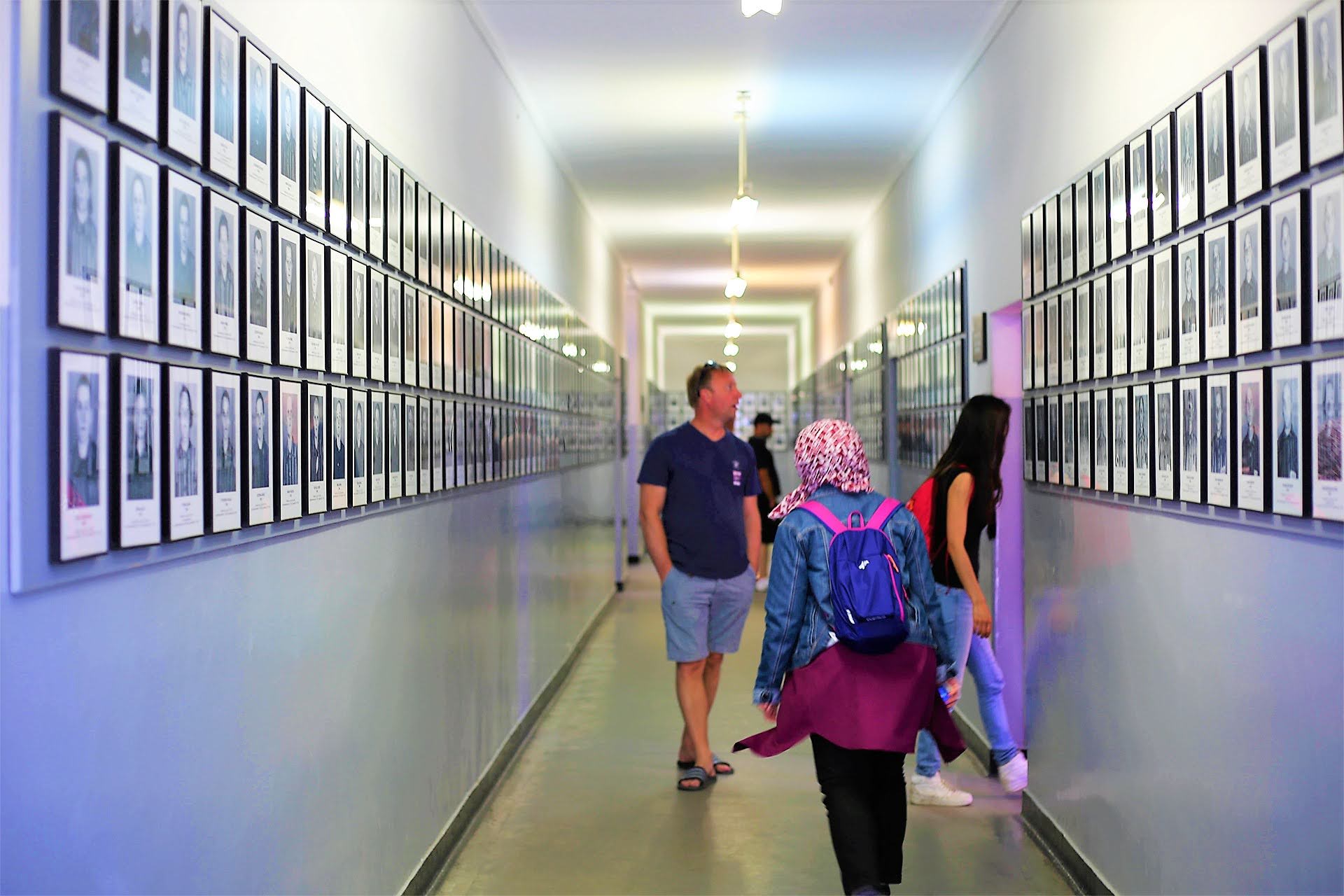 Corridor of prisoner portrait photographs at the Auschwitz Museum